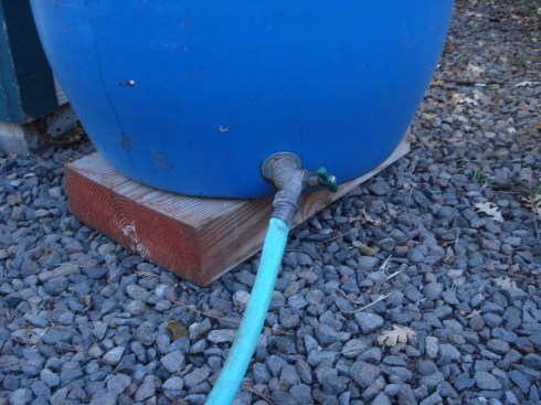 We cut a hole in the bottom, no rocket science required, and easy-as-pie, inserted the valve kit.  Remember to put it on a raised pedestal so you can get pressure in your hose.